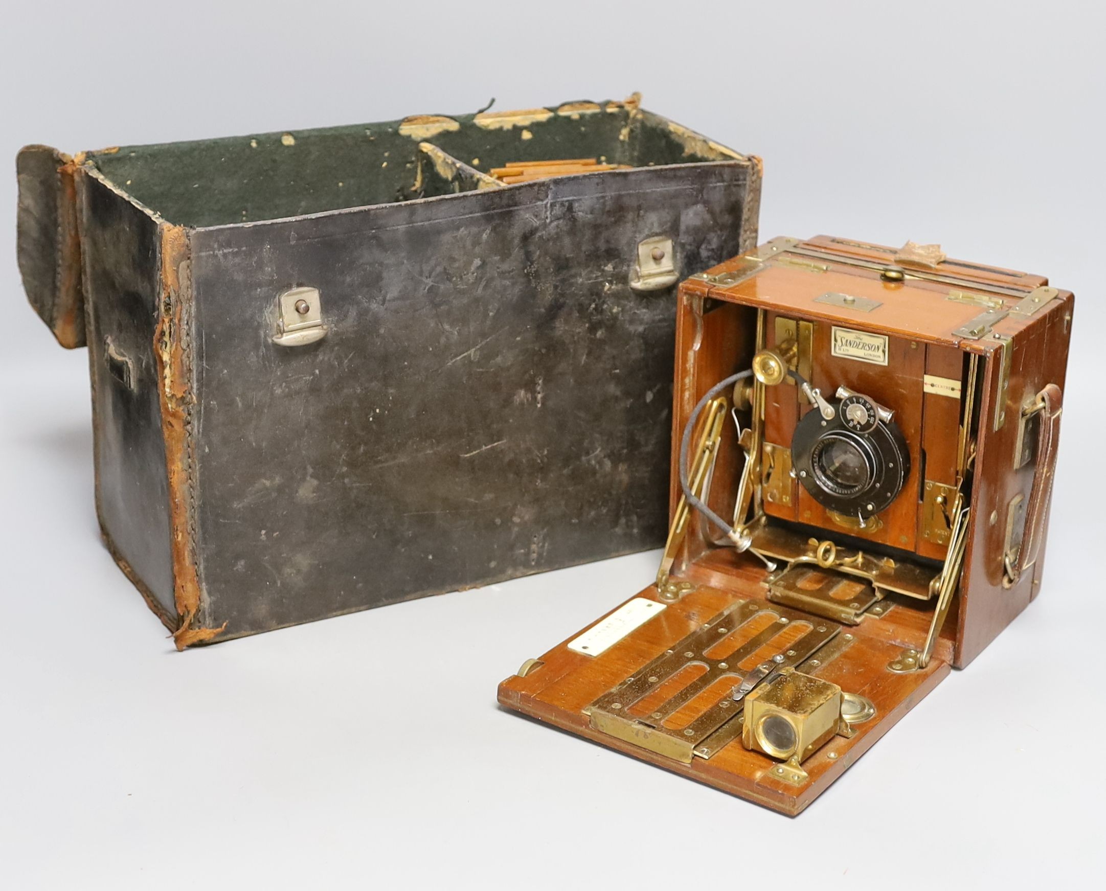 A Sanderson ‘Tropical Model’ plate camera, leather cased with various mahogany plate holders.